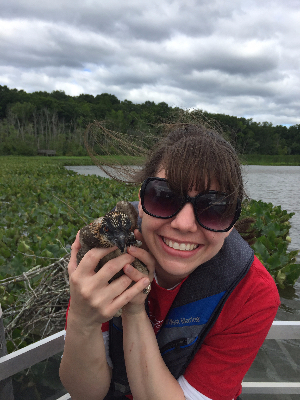 Holding a baby osprey with Patuxent Wildlife Service - collecting data and teaching students about these beautiful predators!